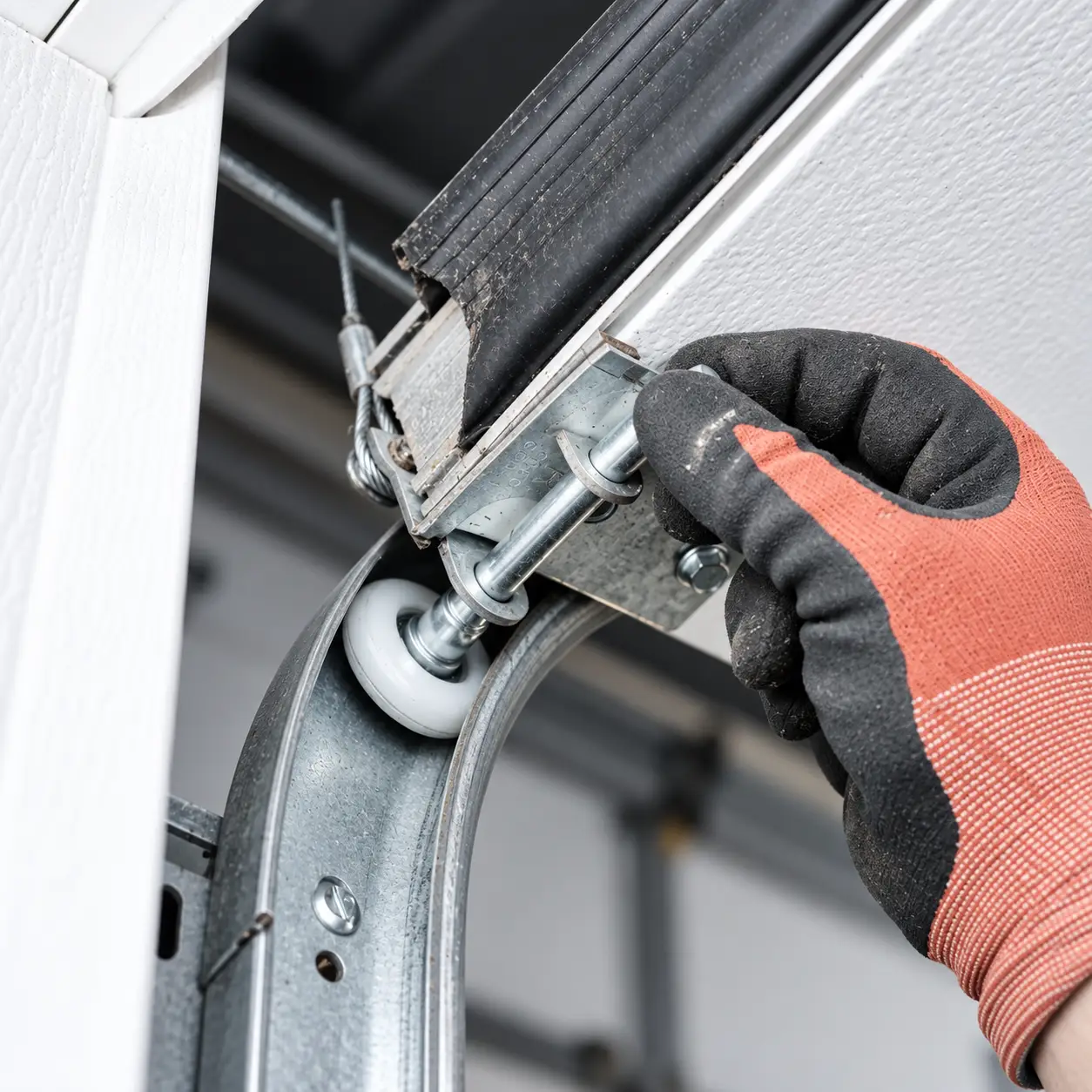 Garage door roller displaced from its track during emergency repair evaluation