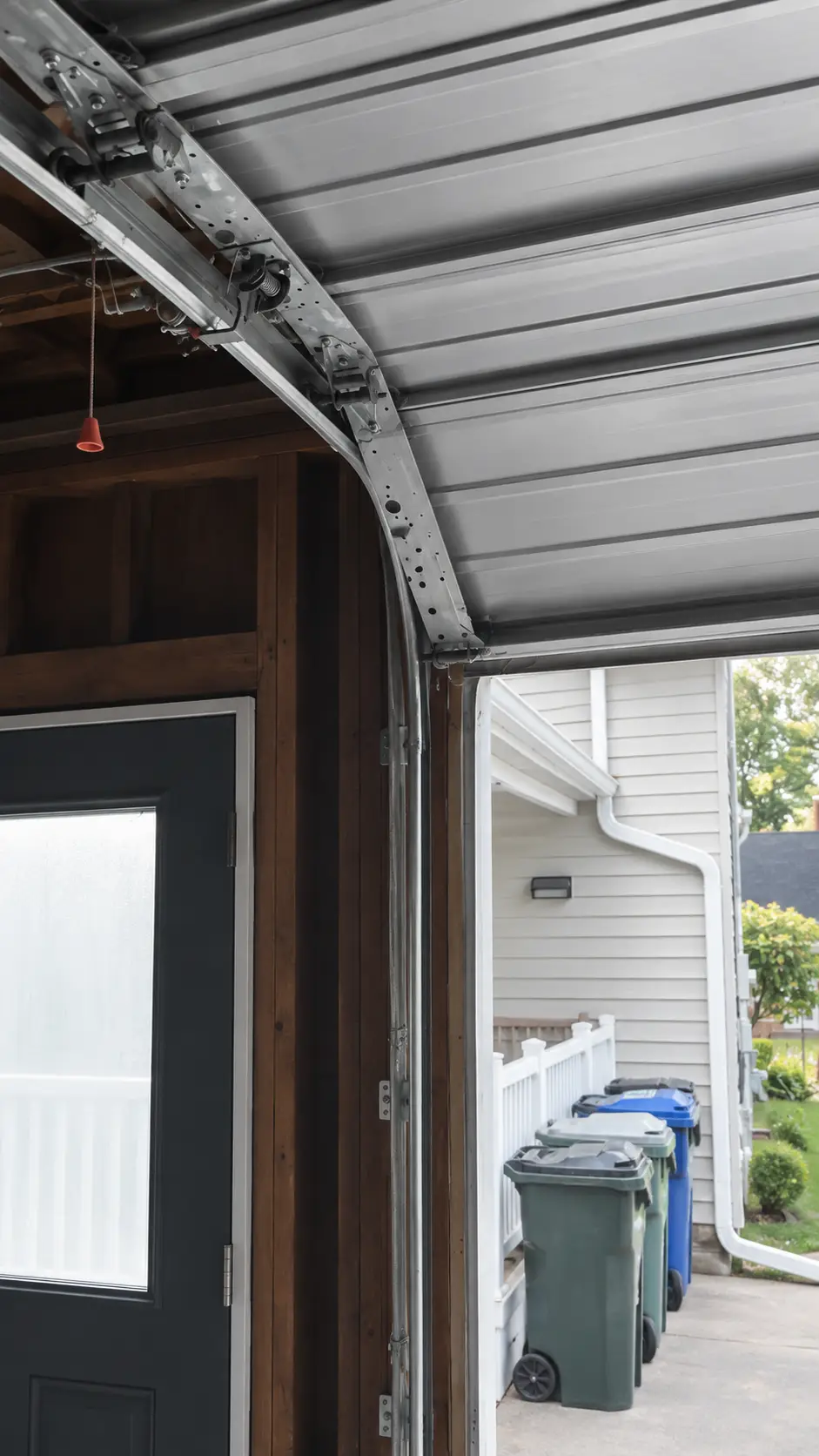 Bent garage door track and roller binding during movement