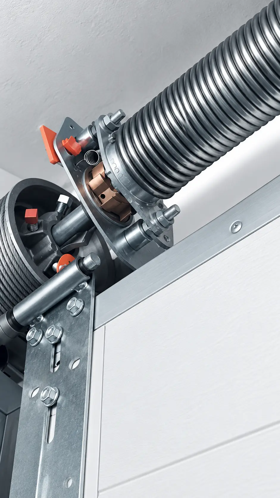Torsion springs shaft and cable drums above a garage door opening